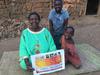 Grandmother Ms. Magdalene , Dorothy Nakyanzi in Background and  in a Pink Top.